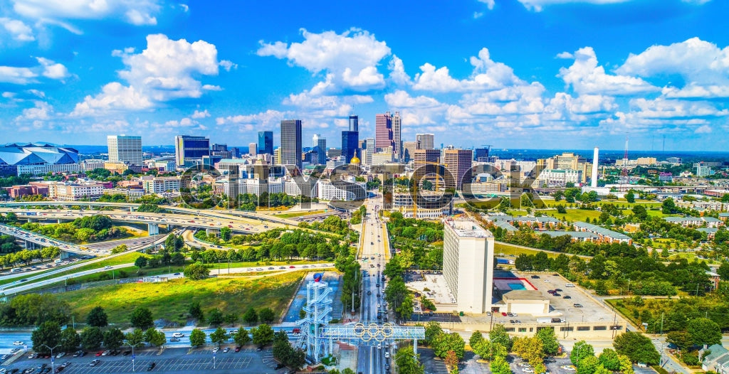 Aerial view of Atlanta skyline with highways under blue skies