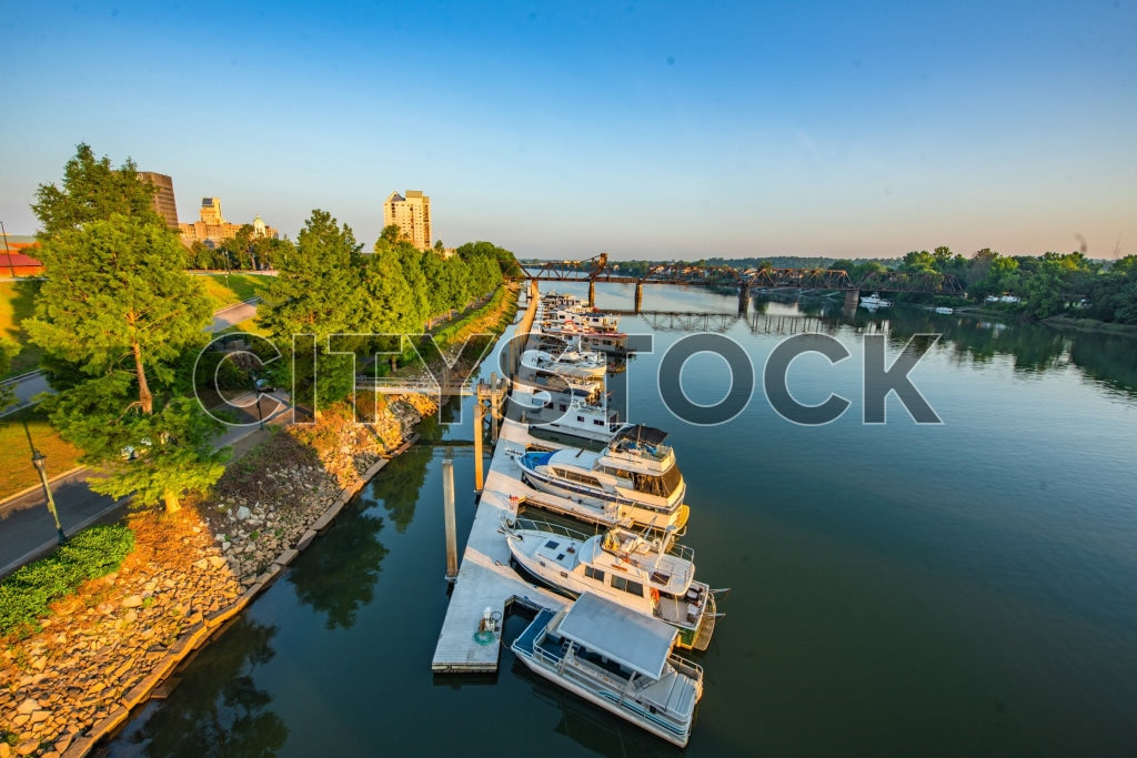 Serene Augusta marina at sunrise with boats and cityscape