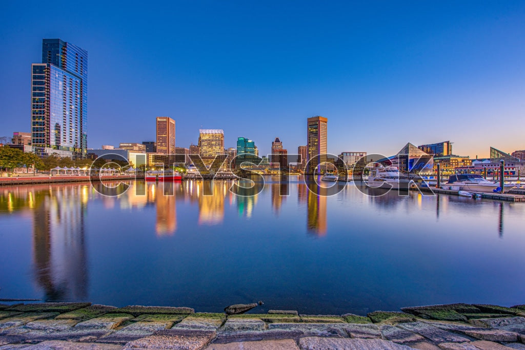 Baltimore harbor with city skyline reflected at sunset