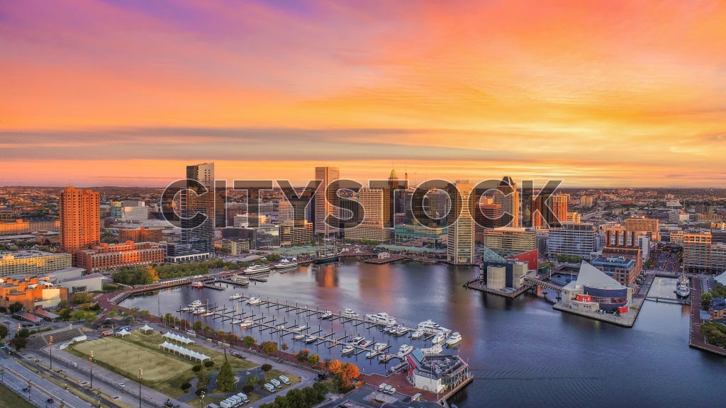 Vibrant sunset over Inner Harbor Baltimore, featuring National Aquarium