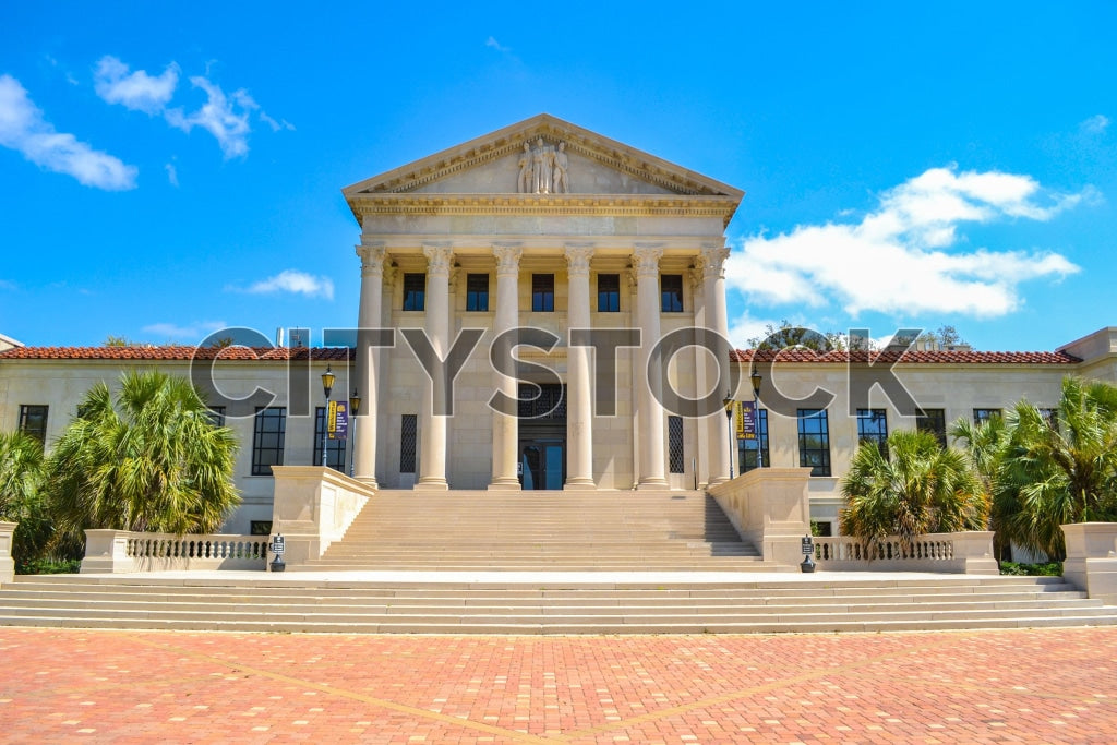 Historic Louisiana State Capitol building with blue skies and palm trees