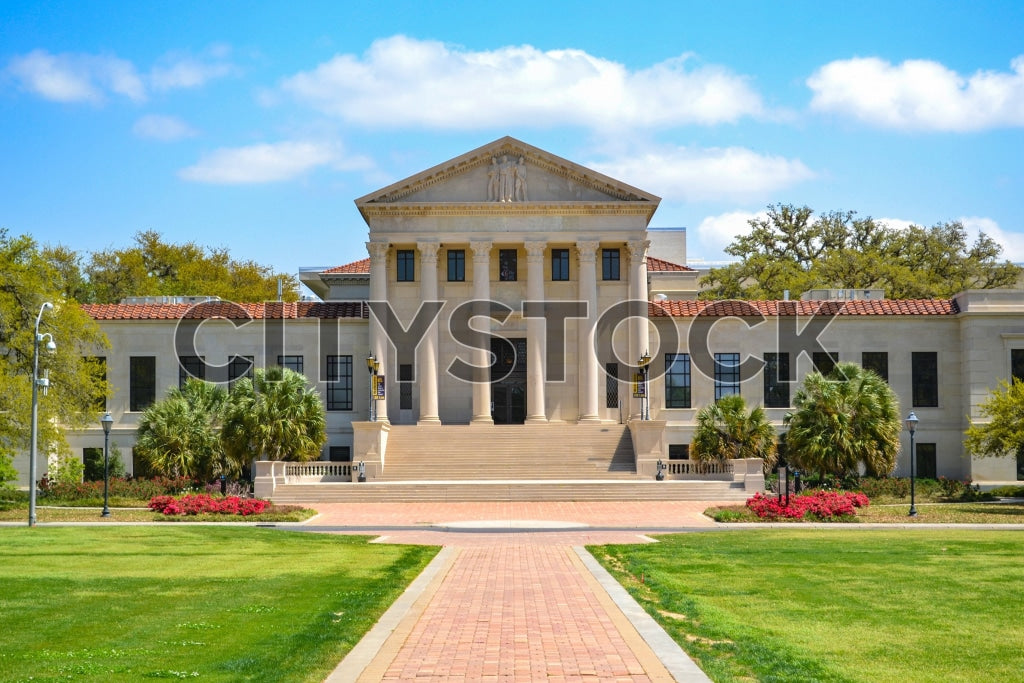 Baton Rouge Courthouse under clear blue sky with vibrant greenery