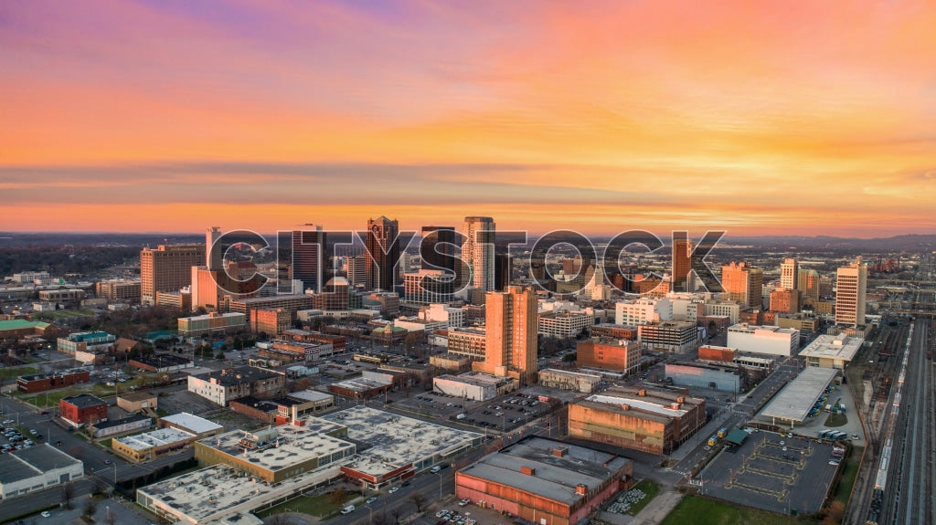 Aerial view of Birmingham, AL skyline at sunset with vibrant skies