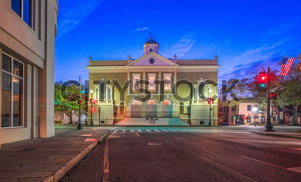 Evening view of historic courthouse with glowing lights in Charleston, SC