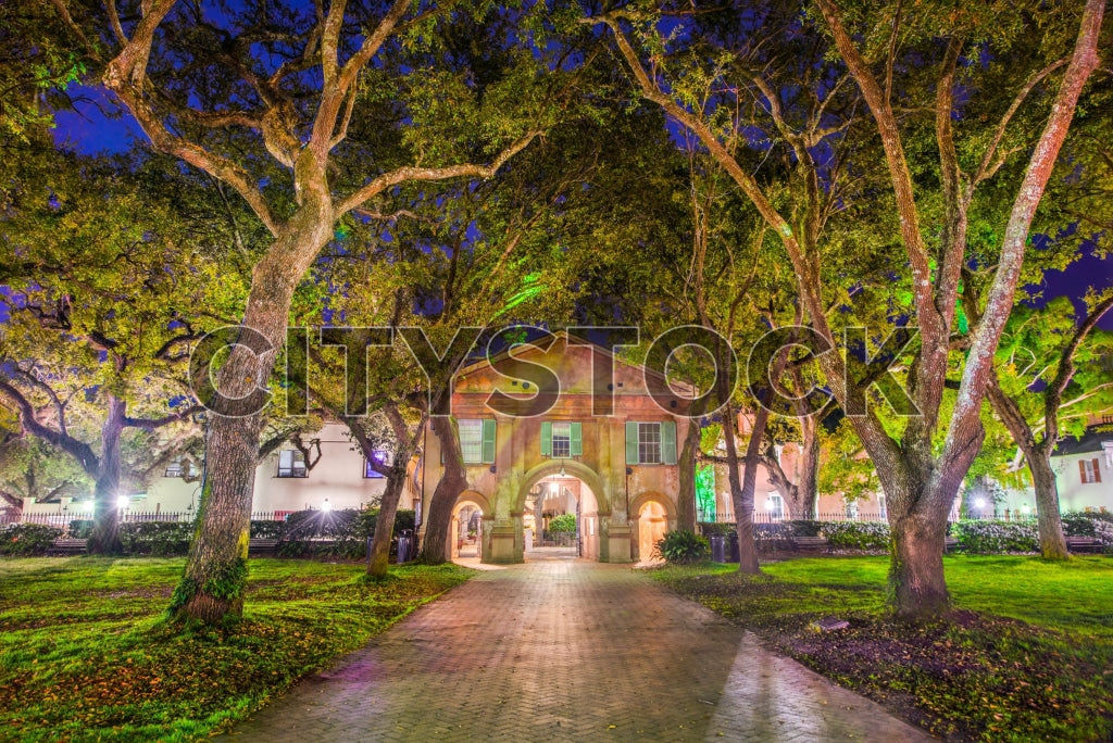 Twilight view of historic buildings along a cobblestone path in Charleston
