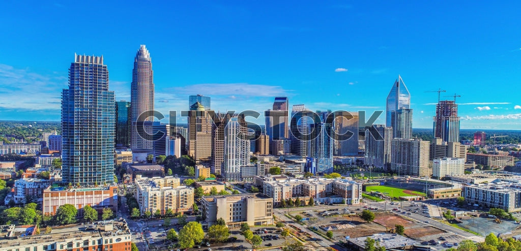 Aerial view of Charlotte NC skyline with blue skies and prominent buildings