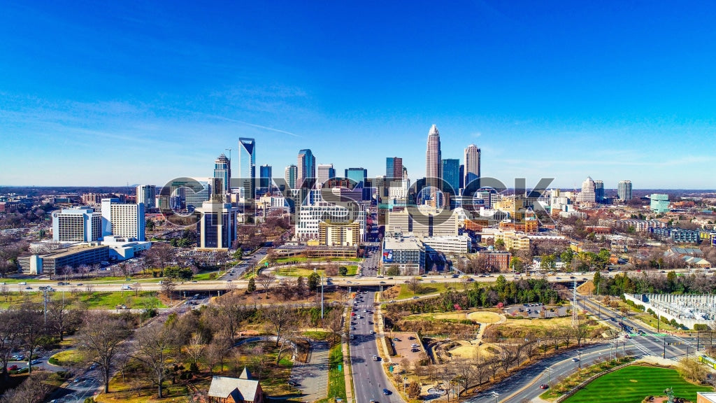 Aerial view of Charlotte NC skyline with skyscrapers and parks on a sunny day