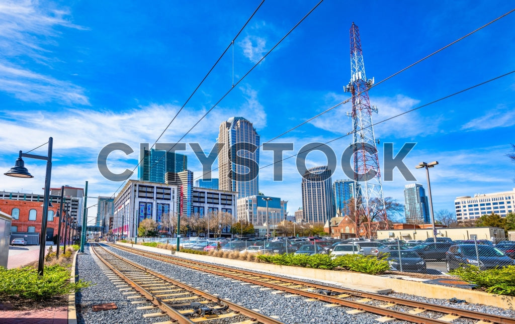 Charlotte NC skyline with railroad tracks under blue sky