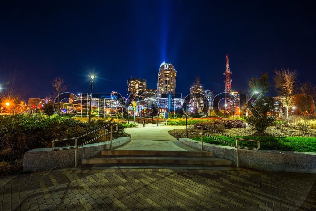 Charlotte NC skyline at night, brightly lit buildings and park