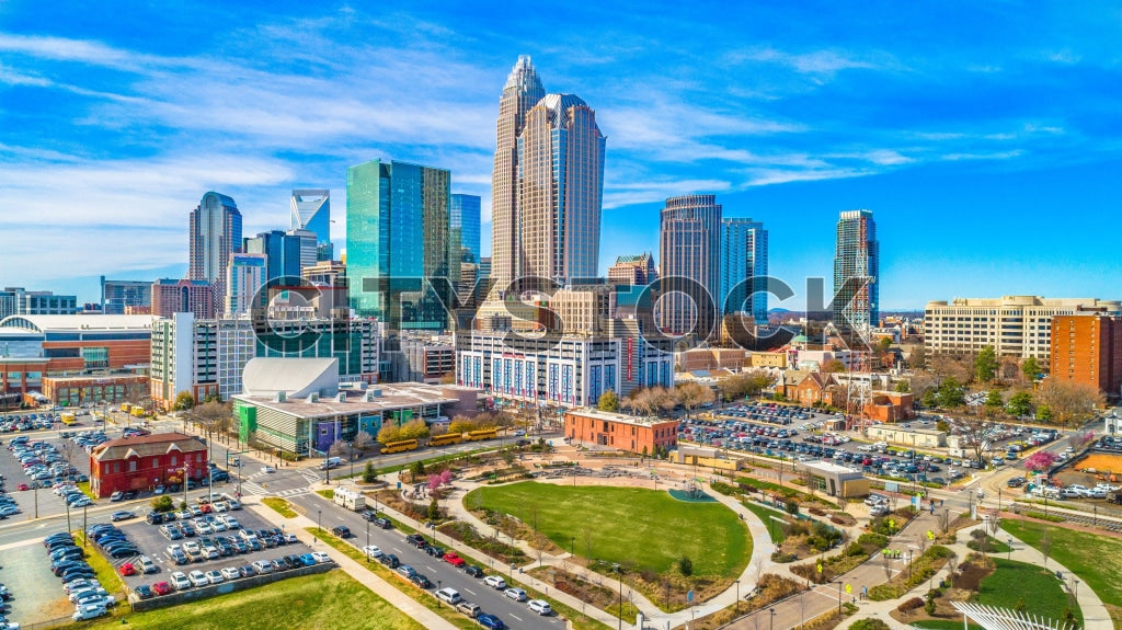Aerial cityscape of Charlotte, NC with modern buildings and park
