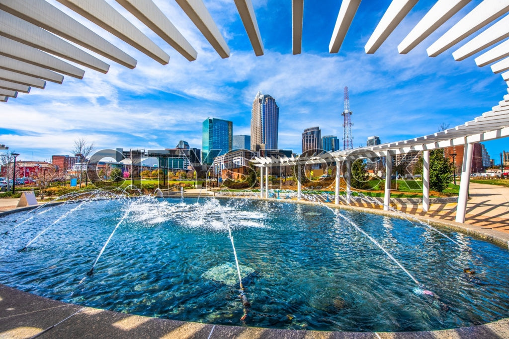 Charlotte, NC skyline and dynamic fountain under bright blue sky