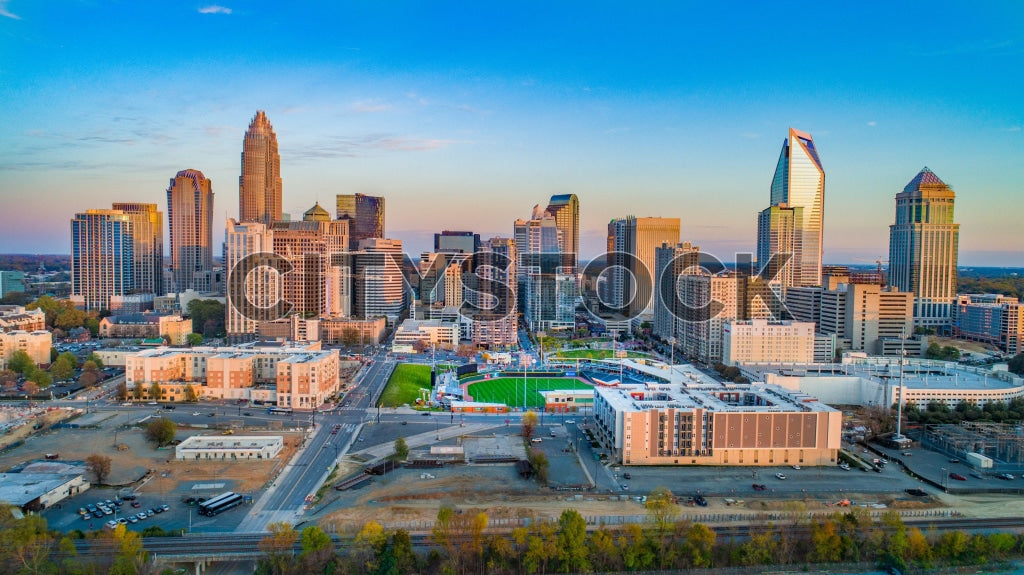 Aerial view of Charlotte's skyline at sunset, featuring prominent skyscrapers