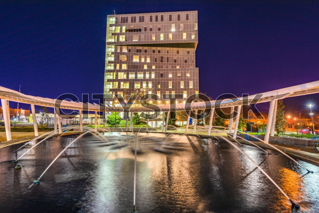 Charlotte cityscape at night with modern buildings and fountain