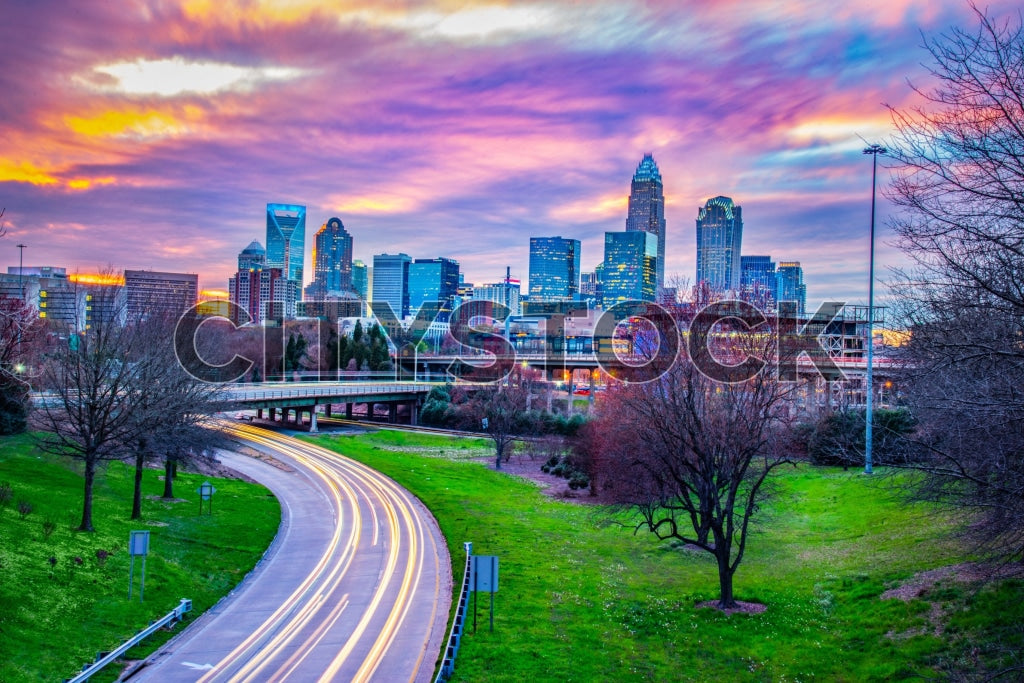 Dramatic sunset over Charlotte NC skyline with vibrant city lights