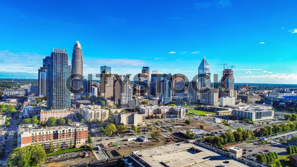 Aerial view of Charlotte, NC skyline with prominent buildings under blue sky