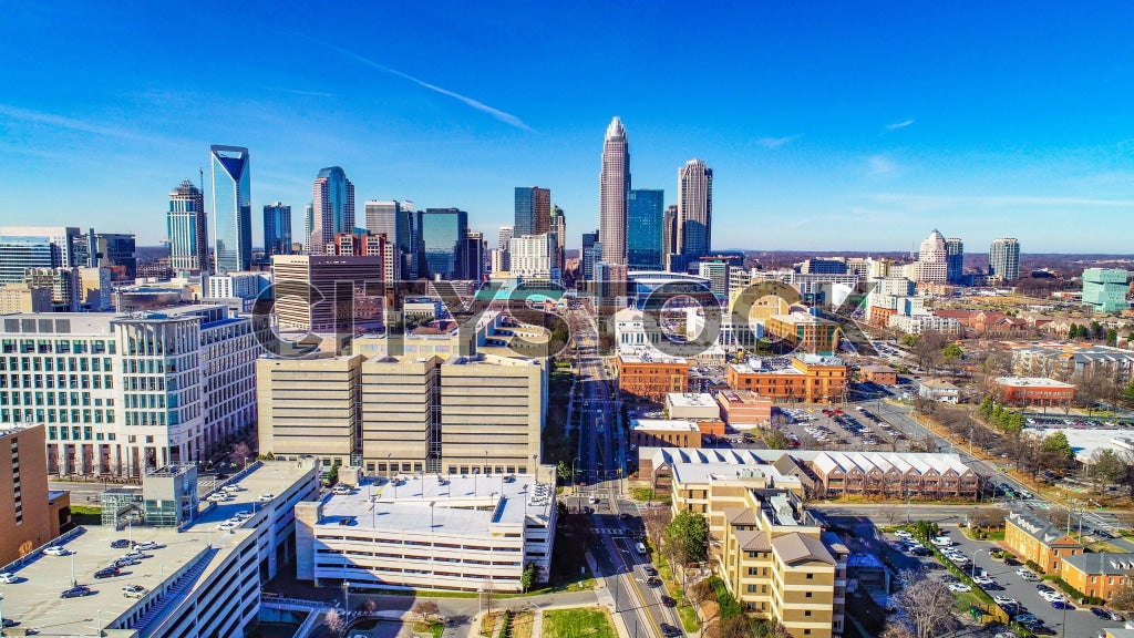 Aerial view of Charlotte NC skyline under bright blue sky