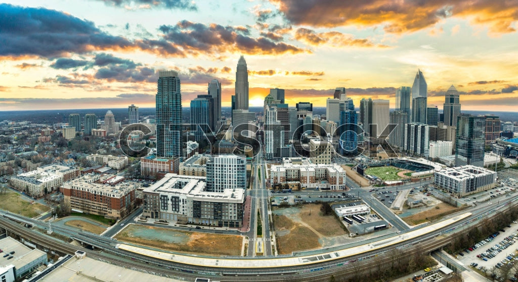 Sunrise illuminating Charlotte downtown buildings and streets