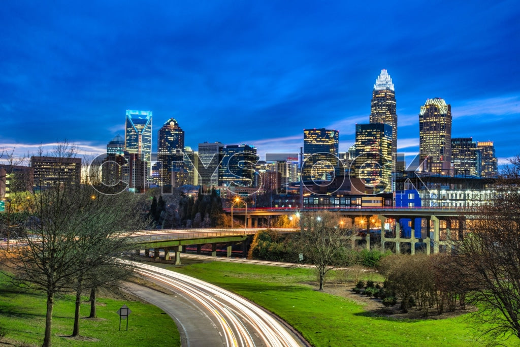 Charlotte NC skyline with bright city lights at dusk