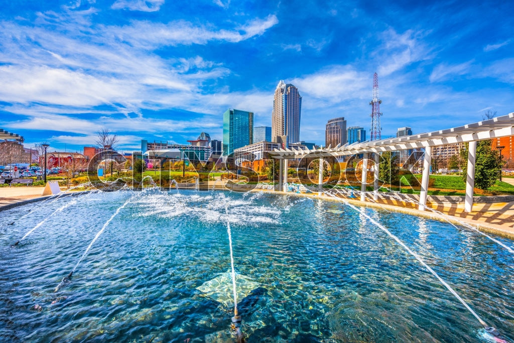 Charlotte skyline and modern water fountain on a sunny day