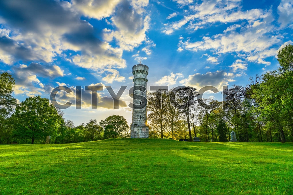 Historical Chattanooga park with stone tower and lush greenery under a blue sky