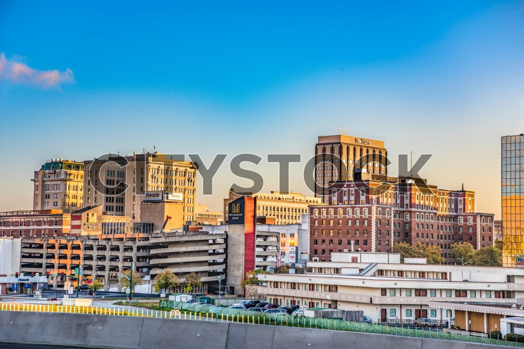 Golden sunset lighting up Chattanooga cityscape with both modern and historic buildings.