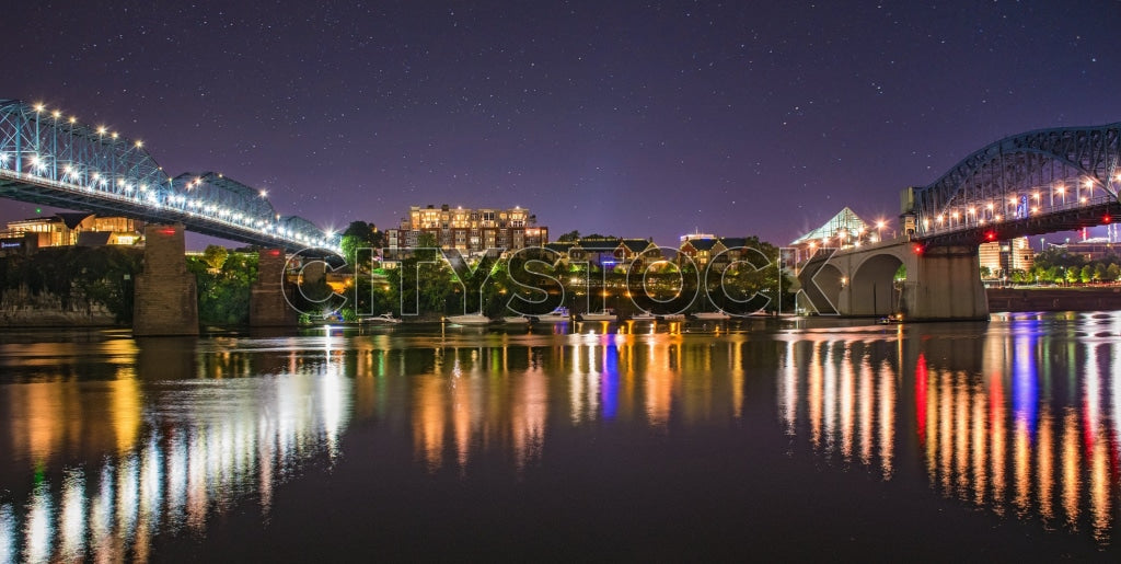 Chattanooga skyline at night with reflective bridge over river
