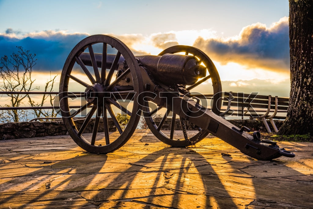 Historic cannon at sunrise in Chattanooga with golden sky