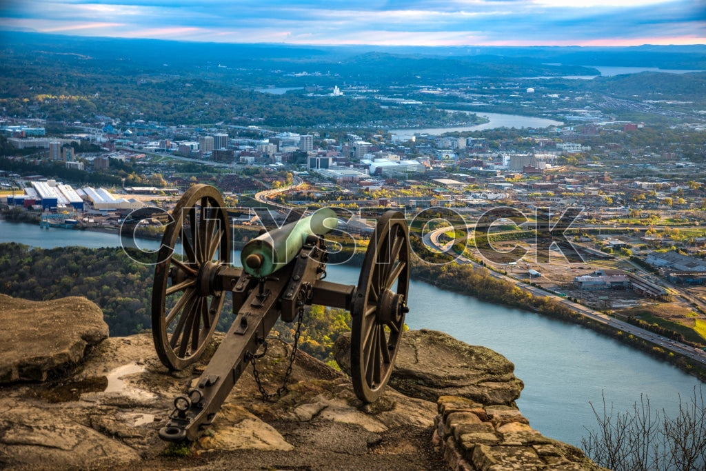 Historic cannon overlooking Chattanooga skyline at dusk with river and mountains