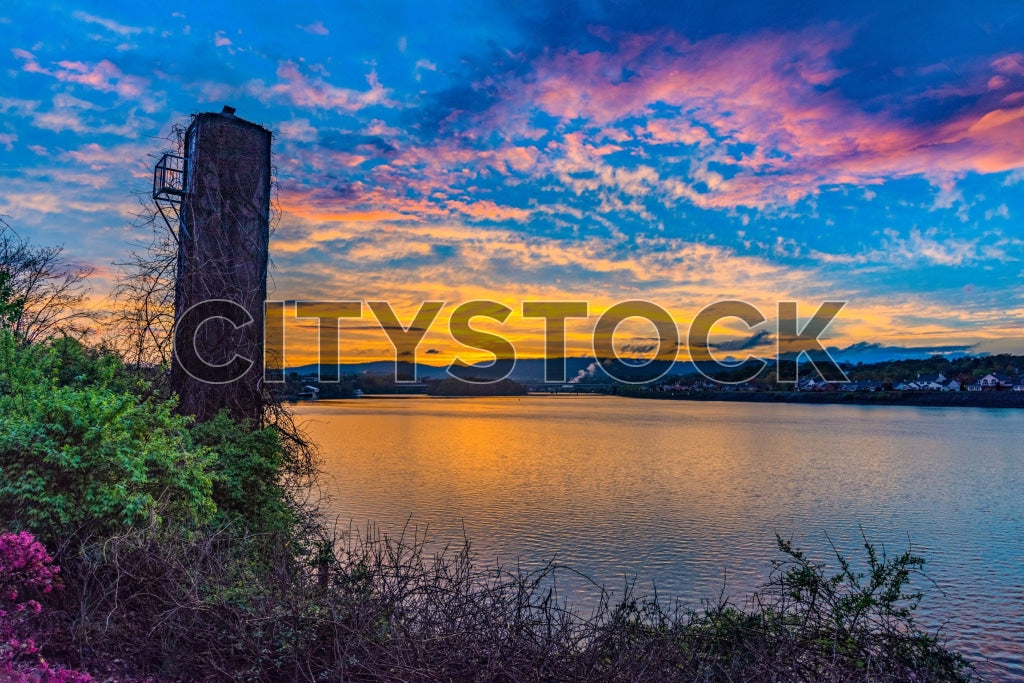 Chattanooga waterfront at sunrise with historic tower and colorful sky