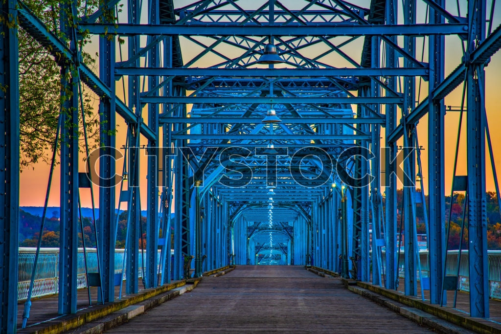 Sunrise view of blue steel bridge over river in Chattanooga, TN