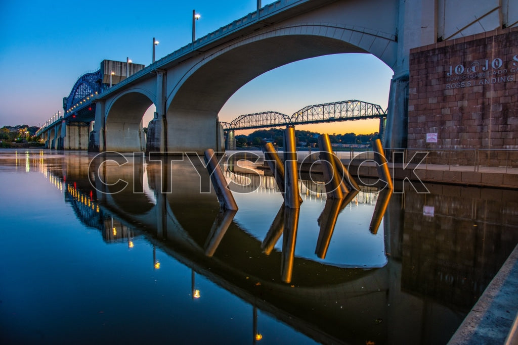 Chattanooga riverfront at sunrise with bridge and reflections