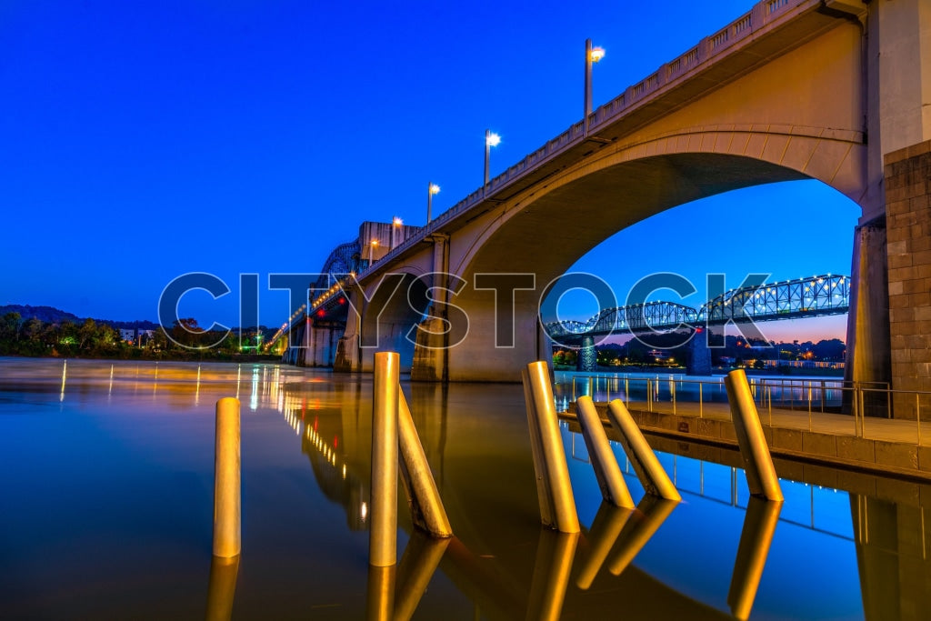 Twilight view of Chattanooga bridge over river with city lights