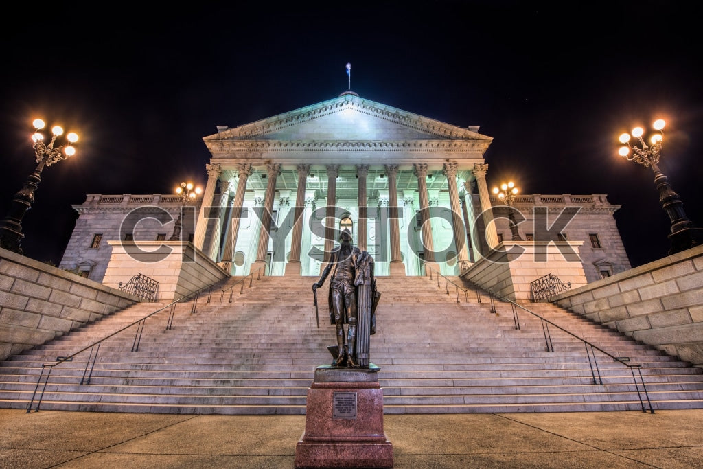 Columbia SC Capitol Building illuminated at night with statues and stairs