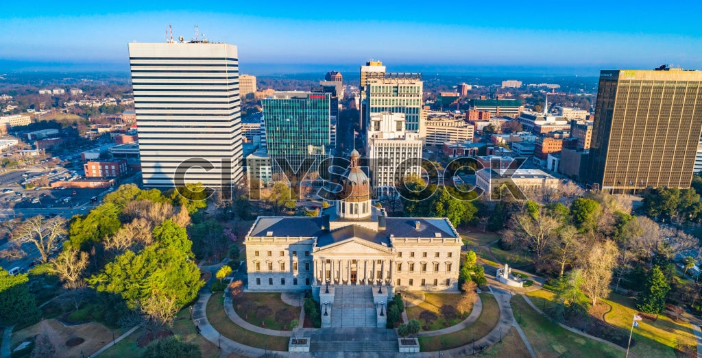 Aerial view of Columbia, SC featuring the State House and city skyline at sunrise