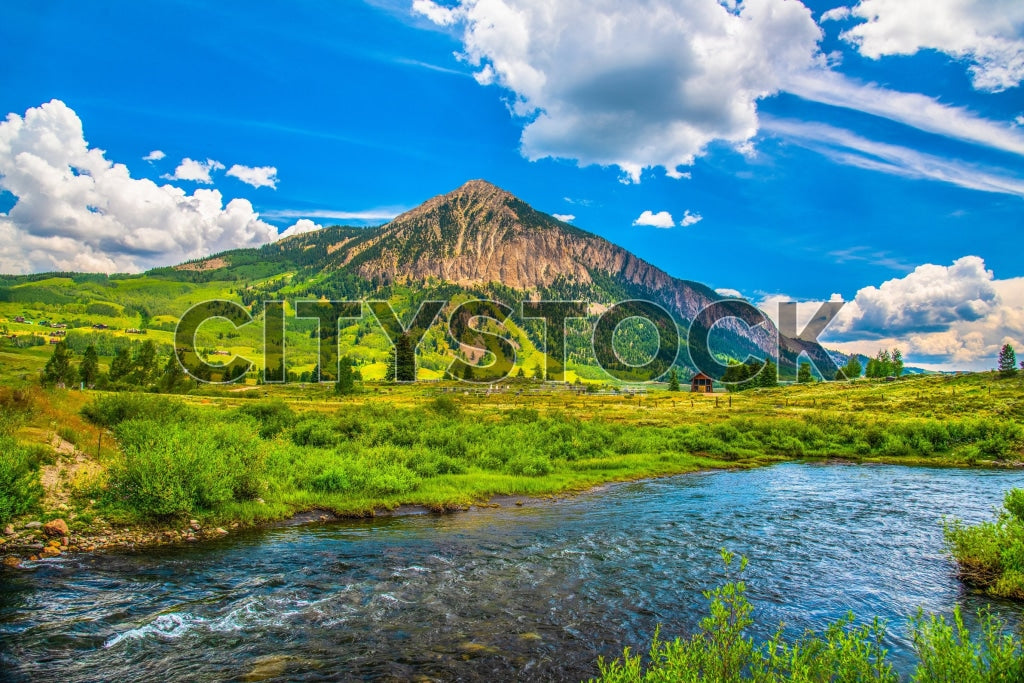 Crested Butte, CO summer landscape with blue river and green fields