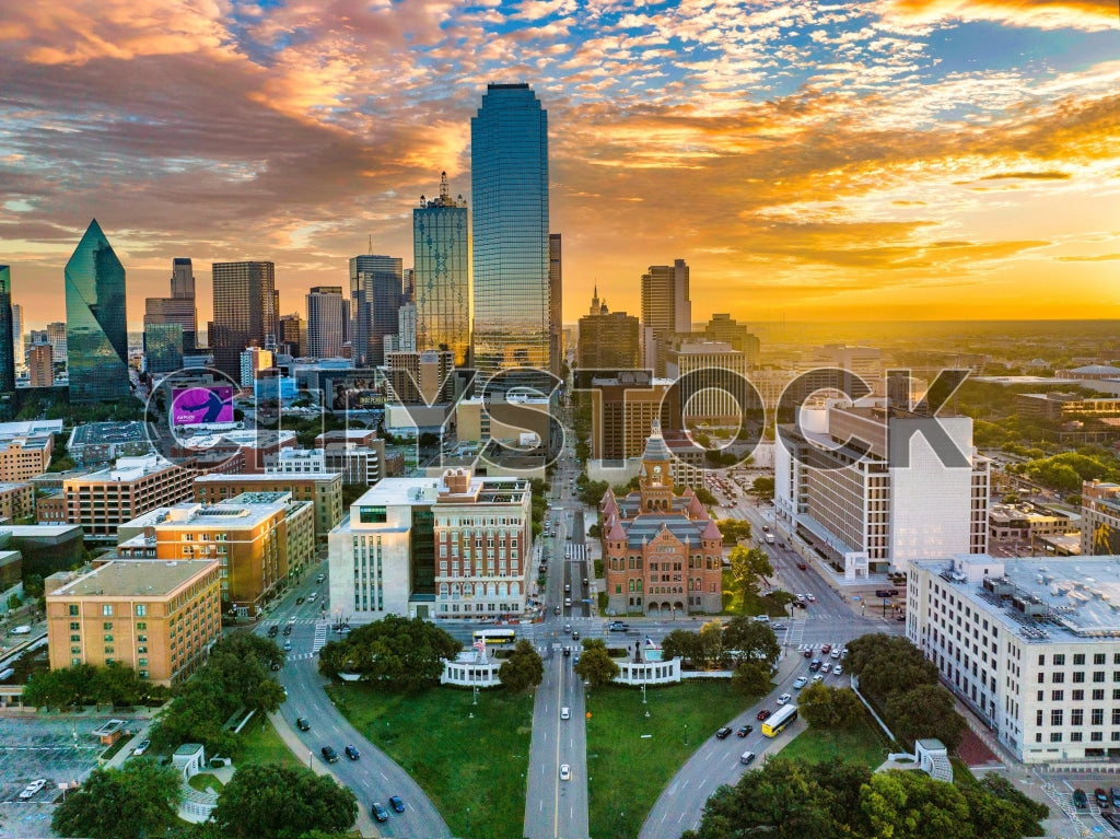 Aerial view of Dallas skyline at sunrise with colorful clouds