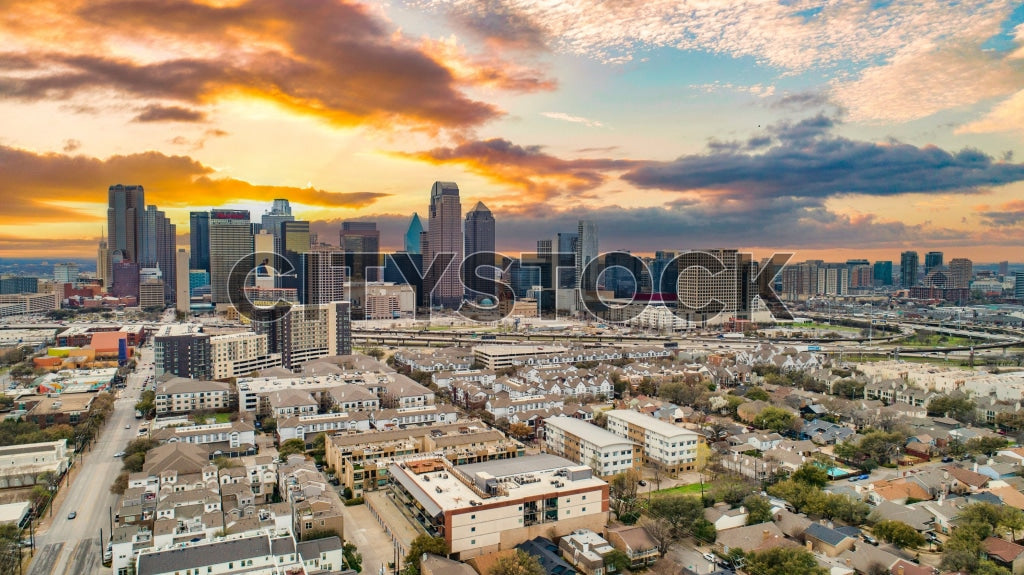 Aerial view of Dallas skyline at sunrise with colorful sky