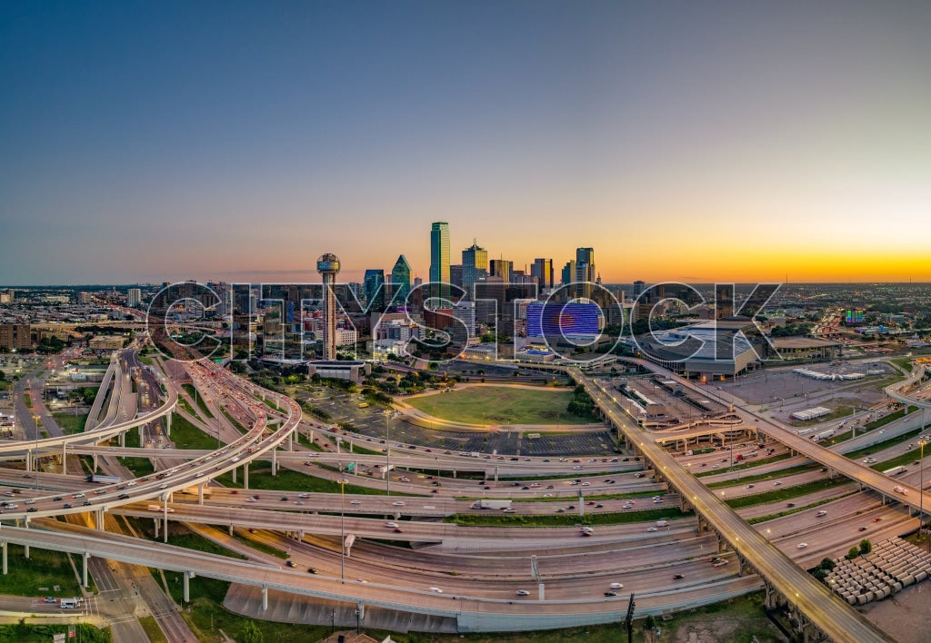 Aerial view of Dallas skyline at sunset with lighted highways