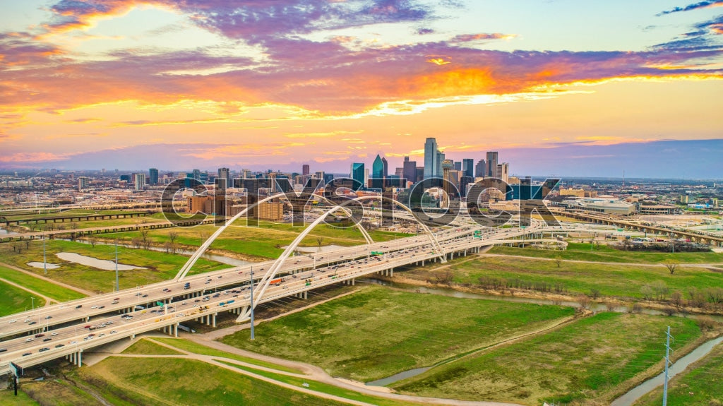 Aerial view of Dallas skyline at sunset with busy highways