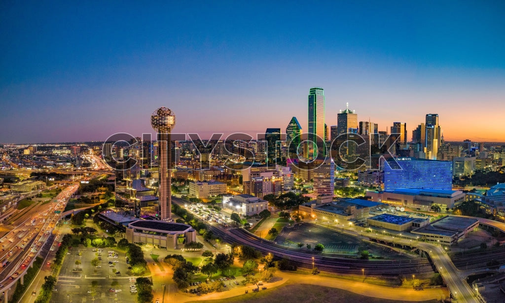 Aerial view of Dallas skyline at sunset, with visible landmarks
