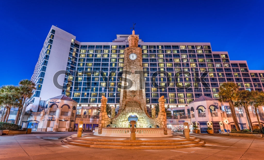Twilight at Daytona Beach with illuminated clock tower and modern high-rises