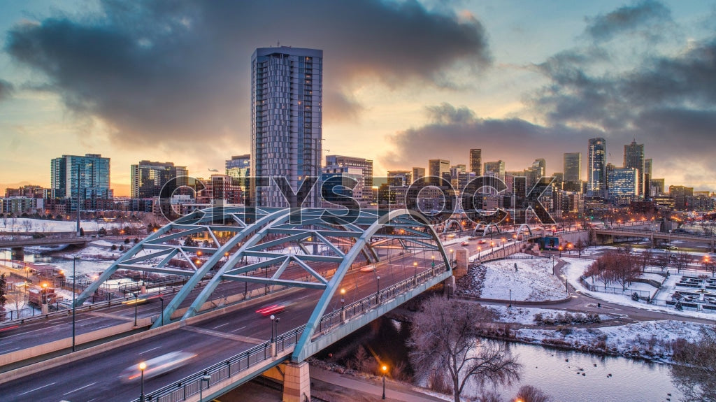 Denver skyline under winter sunset with snowy urban scene