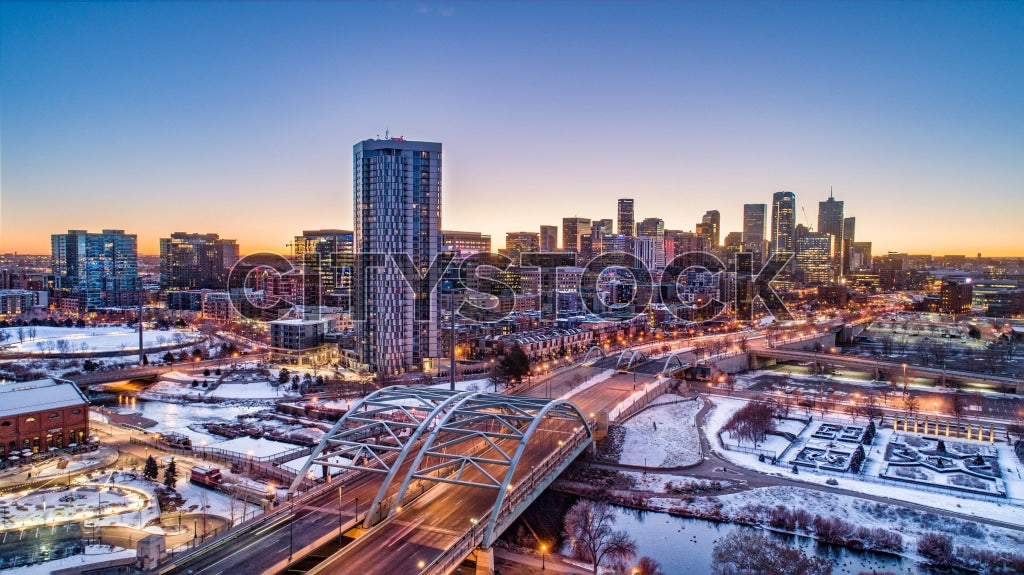 Aerial view of Denver, Colorado at sunrise in winter, showing city lights and skyline
