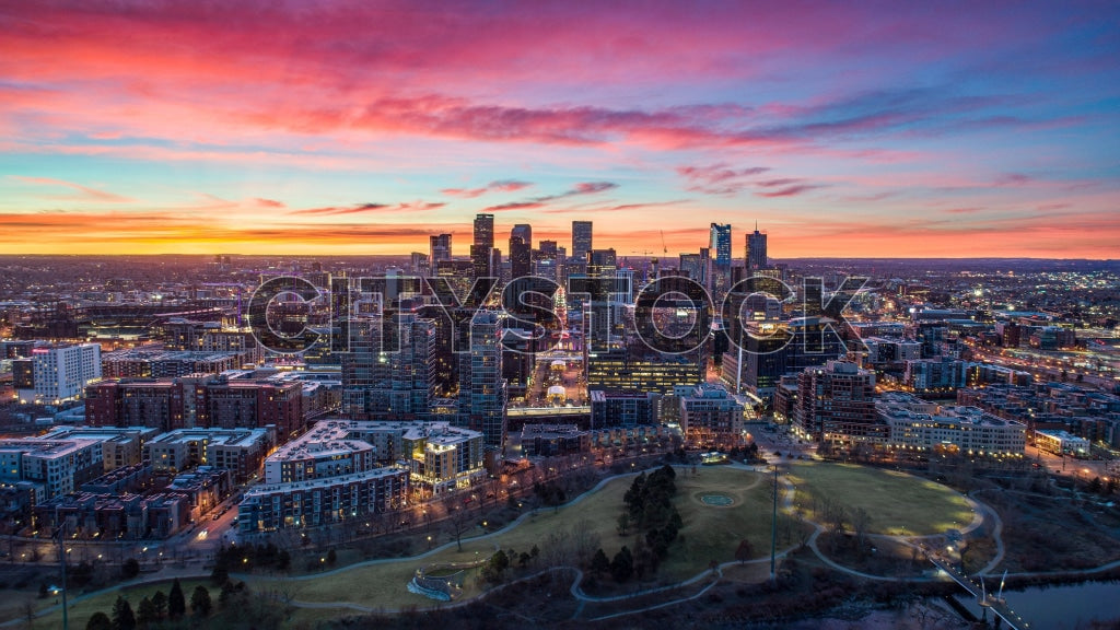 Aerial view of Denver, Colorado at sunset with vibrant skies and city lights