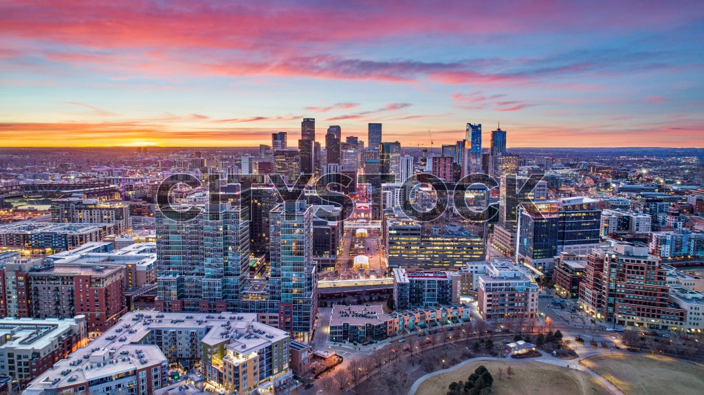 Aerial view of Denver skyline with vivid sunset colors