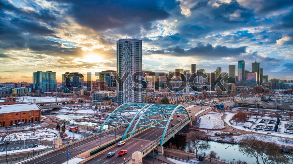 Winter sunrise illuminating Denver's skyline with snowy parks