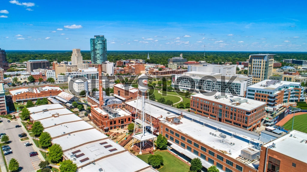 Aerial cityscape of downtown Durham, North Carolina, under blue skies