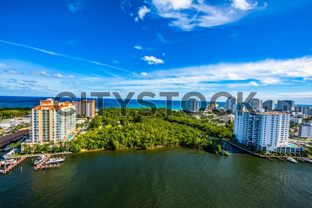 Aerial view of Fort Lauderdale's urban and coastal skyline under blue sky