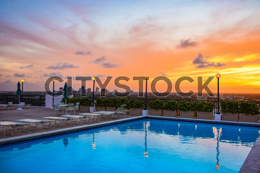 Sunset over Fort Lauderdale cityscape from a rooftop pool