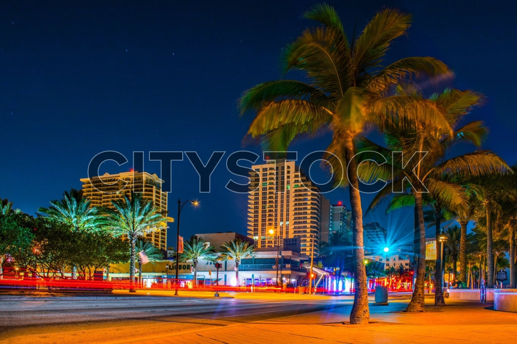 Fort Lauderdale street at twilight with vivid palm trees and lights